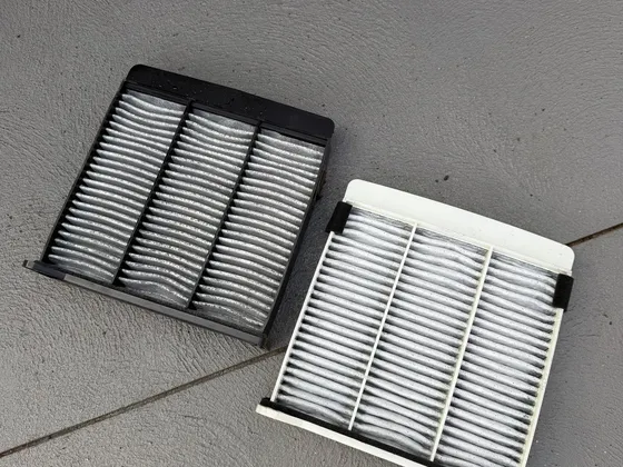 New cabin air filter next to the dirty one removed during servicing