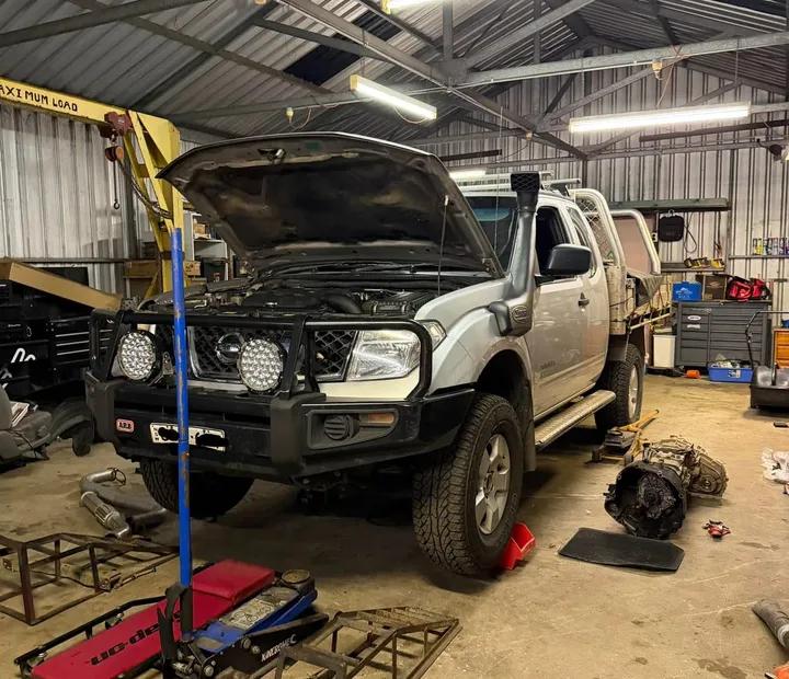 Nissan Navara up on stands during a mechanical repair in the RSG workshop