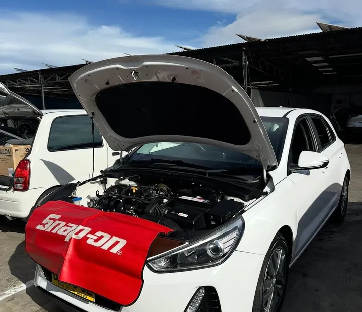 Hyundai i30 with the bonnet up during a mobile service by RSG Mechanical