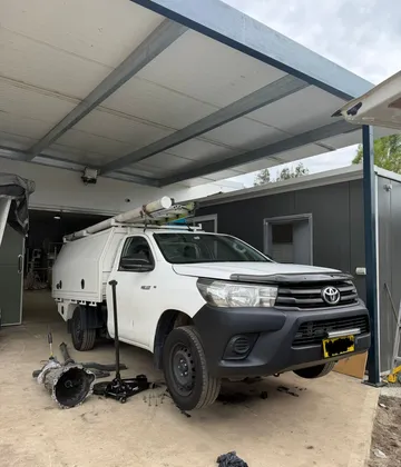Gearbox repair on a Toyota Hilux under a customer carport