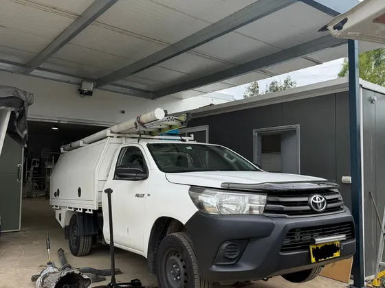 Toyota Hilux with gearbox removed during a mobile repair
